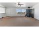 Open living room with front door, view windows, and a wood burning fireplace at 70 Camp Bonanza Rd, Las Vegas, NV 89124