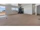 Open-concept living room with sliding doors to a deck and a wood burning fireplace at 70 Camp Bonanza Rd, Las Vegas, NV 89124