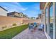 Cozy backyard featuring a brick patio, artificial grass, and stylish patio furniture at 7107 Tilligerry St, North Las Vegas, NV 89084