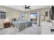 Comfortable bedroom featuring carpet, a ceiling fan, and a private balcony with scenic views at 7107 Tilligerry St, North Las Vegas, NV 89084