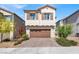 Charming two-story home with a two-car garage and beautiful landscaping at 7107 Tilligerry St, North Las Vegas, NV 89084