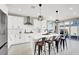 Sleek kitchen featuring a center island with seating, stainless appliances, and bright white cabinetry at 7107 Tilligerry St, North Las Vegas, NV 89084