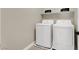 Modern laundry room equipped with a washer, a dryer, and a shelf for storage at 7107 Tilligerry St, North Las Vegas, NV 89084
