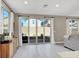 Bright living room with tile flooring, sliding glass doors, and neutral-toned walls at 7107 Tilligerry St, North Las Vegas, NV 89084
