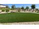 Well-maintained park featuring a large green space and desert landscaping with walking paths at 7107 Tilligerry St, North Las Vegas, NV 89084