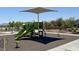 Community playground with slides, climbing structures, and shaded seating areas for Gathering fun at 7107 Tilligerry St, North Las Vegas, NV 89084