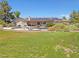 Expansive backyard featuring a lush lawn, inviting pool, and solar panels on the roof at 731 W Calvada Blvd, Pahrump, NV 89048