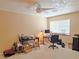 Bedroom with neutral walls, ceiling fan, and a large window providing natural light at 731 W Calvada Blvd, Pahrump, NV 89048