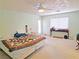 Bright primary bedroom featuring a large bed, ceiling fan, and natural light at 731 W Calvada Blvd, Pahrump, NV 89048