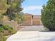 Gated entrance with a view of the home and a large garage at 731 W Calvada Blvd, Pahrump, NV 89048