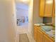 Hallway featuring tile flooring and wooden cabinets, providing a glimpse into the living areas at 731 W Calvada Blvd, Pahrump, NV 89048
