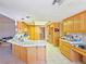 Spacious kitchen with light wood cabinets, a tile countertop, and ample counter space at 731 W Calvada Blvd, Pahrump, NV 89048