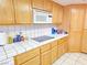 Kitchen with light wood cabinets, white appliances, and a white tile backsplash at 731 W Calvada Blvd, Pahrump, NV 89048