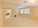 Spacious living room featuring natural light from two windows and neutral carpeting at 731 W Calvada Blvd, Pahrump, NV 89048
