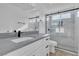 Bright renovated bathroom featuring a new vanity with stone counter and a glass-enclosed shower at 765 Butternut Ct, Henderson, NV 89014