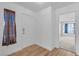 Bright foyer featuring wood floors, a front door, and a view into a bedroom at 765 Butternut Ct, Henderson, NV 89014