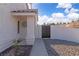 View of the front entrance with a gate, textured facade, and stone landscaping at 765 Butternut Ct, Henderson, NV 89014