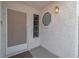 Covered front porch with textured walls, security door, and unique window at 765 Butternut Ct, Henderson, NV 89014