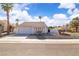 Charming single-story home with desert landscaping, tile roof, and two-car garage at 765 Butternut Ct, Henderson, NV 89014
