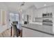 Bright kitchen with gray quartz countertops, white cabinetry, and stainless steel appliances at 765 Butternut Ct, Henderson, NV 89014