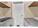 A clean laundry room with modern appliances and a pet door at 765 Butternut Ct, Henderson, NV 89014