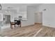 Living room with wood floors open to the dining area and modern kitchen at 765 Butternut Ct, Henderson, NV 89014