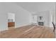 Open concept living room with wood floors, fireplace, and neutral paint at 765 Butternut Ct, Henderson, NV 89014