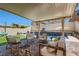 Resort-style backyard with a pool, patio, lounge seating, and lush landscaping at 7761 Sagamore Bay Ct, Las Vegas, NV 89179