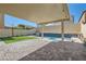 Backyard with covered patio and a blue tiled water feature cascading into the pool at 7761 Sagamore Bay Ct, Las Vegas, NV 89179