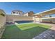 Backyard with a firepit and a water feature cascading into a sparkling pool at 7761 Sagamore Bay Ct, Las Vegas, NV 89179