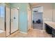 Bathroom features a glass shower enclosure, tile flooring, and a view into the bonus room at 7761 Sagamore Bay Ct, Las Vegas, NV 89179