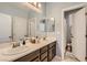 Bright bathroom with a double sink vanity, large mirror, and an open doorway to the toilet at 7761 Sagamore Bay Ct, Las Vegas, NV 89179