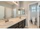 Bathroom featuring dual sinks and a large mirror with access to a shower and toilet at 7761 Sagamore Bay Ct, Las Vegas, NV 89179