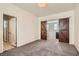 This spacious bedroom features barn doors, carpet floors, and a modern ceiling light at 7761 Sagamore Bay Ct, Las Vegas, NV 89179