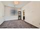 Bright bedroom featuring carpet floors, a large window, and neutral wall paint at 7761 Sagamore Bay Ct, Las Vegas, NV 89179