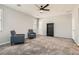 Bonus room features neutral tones, carpet, ceiling fan and lots of natural light at 7761 Sagamore Bay Ct, Las Vegas, NV 89179