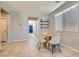 Bright dining area with tile floors, modern furnishings, and natural light from a window at 7761 Sagamore Bay Ct, Las Vegas, NV 89179