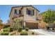 Charming two-story home with a well-manicured lawn, desert landscaping, and a two-car garage at 7761 Sagamore Bay Ct, Las Vegas, NV 89179