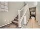 Hallway featuring carpeted stairs, shoe storage and an opening to the living room at 7761 Sagamore Bay Ct, Las Vegas, NV 89179