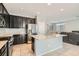 Open kitchen with granite countertops, stainless steel appliances, and tile flooring at 7761 Sagamore Bay Ct, Las Vegas, NV 89179