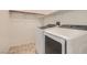 Practical laundry room with side-by-side washer and dryer and tiled floors at 7761 Sagamore Bay Ct, Las Vegas, NV 89179