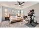 Spacious main bedroom with a ceiling fan, natural light, and ample space for relaxation at 7761 Sagamore Bay Ct, Las Vegas, NV 89179