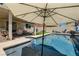 Backyard pool featuring a covered patio and shaded seating area, perfect for summer relaxation at 7761 Sagamore Bay Ct, Las Vegas, NV 89179
