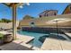 Inviting pool with built-in waterfall and patio area perfect for outdoor entertaining at 7761 Sagamore Bay Ct, Las Vegas, NV 89179