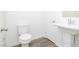 A well-lit half bathroom featuring a toilet and pedestal sink at 7777 Vino Vranec Ct, Las Vegas, NV 89113