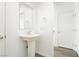 Bright bathroom with a pedestal sink, a decorative mirror and white trim at 7777 Vino Vranec Ct, Las Vegas, NV 89113