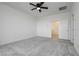 This bedroom features a ceiling fan, plush carpet and an entry way to a closet at 7777 Vino Vranec Ct, Las Vegas, NV 89113
