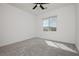 A bright bedroom features a ceiling fan and a window with scenic views at 7777 Vino Vranec Ct, Las Vegas, NV 89113
