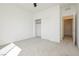 Bright bedroom featuring gray carpet, ceiling fan, and a closet with sliding doors at 7777 Vino Vranec Ct, Las Vegas, NV 89113