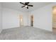 This bedroom features a ceiling fan, plush carpet and an entry way to a closet at 7777 Vino Vranec Ct, Las Vegas, NV 89113